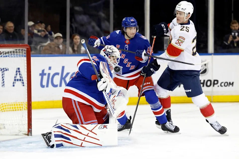 Rangers goaltender Igor Shesterkin makes a save while teammate New York Rangers defenseman Drew Fortescue (C) protects the net from Florida Panthers left wing Nolan Foote in the first second at Madison Square Garden. New York. JASON SZENES FOR THE NEW YORK POST