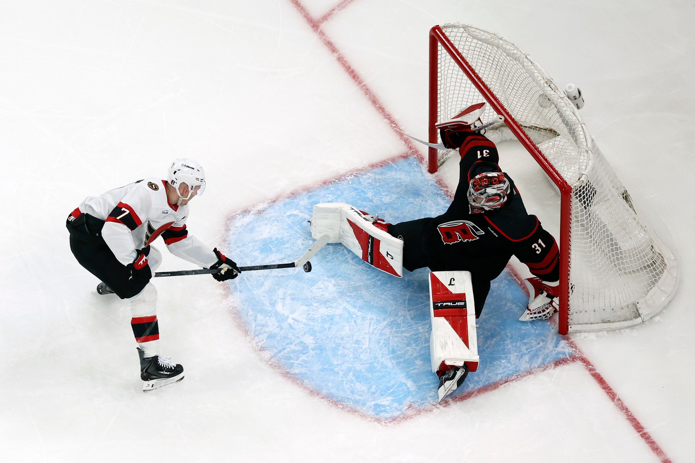 RALEIGH, NORTH CAROLINA - APRIL 18: Frederik Andersen #31 of the Carolina Hurricanes makes a save against Brady Tkachuk #7 of the Ottawa Senators during the third period of the game at Lenovo Center on April 18, 2026 in Raleigh, North Carolina. (Photo by Jared C. Tilton/Getty Images)