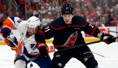 Carolina Hurricanes' Alexander Nikishin (21) battles for position with New York Islanders' Max Shabanov (49) during an NHL hockey game in Raleigh, N.C., Saturday, April 4, 2026. (AP Photo/Karl DeBlaker)