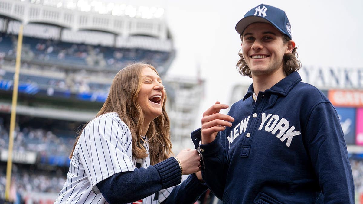 New Jersey Devil Jack Hughes jokes with Olympic hockey player Aerin Frankel at Yankee Stadium