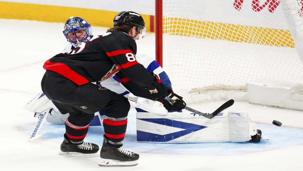 Ottawa Senators' Jake Sanderson (85) scores on Tampa Bay Lightning goaltender Jonas Johansson (31) during the third period of an NHL hockey game in Ottawa, Ontario, on Tuesday, April 7, 2026. (Sean Kilpatrick/The Canadian Press via AP)