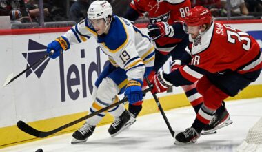 Buffalo Sabres center Peyton Krebs (19) competes for the puck with Washington Capitals defenseman Rasmus Sandin during the second period of an NHL Hockey game, Saturday, April 4, 2026, in Washington. (AP Photo/John McDonnell)