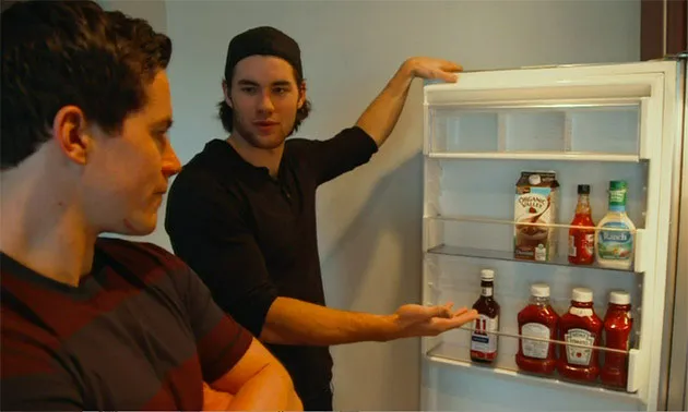 Tom Wilson shows off his refrigerator with Michael Latta looking on