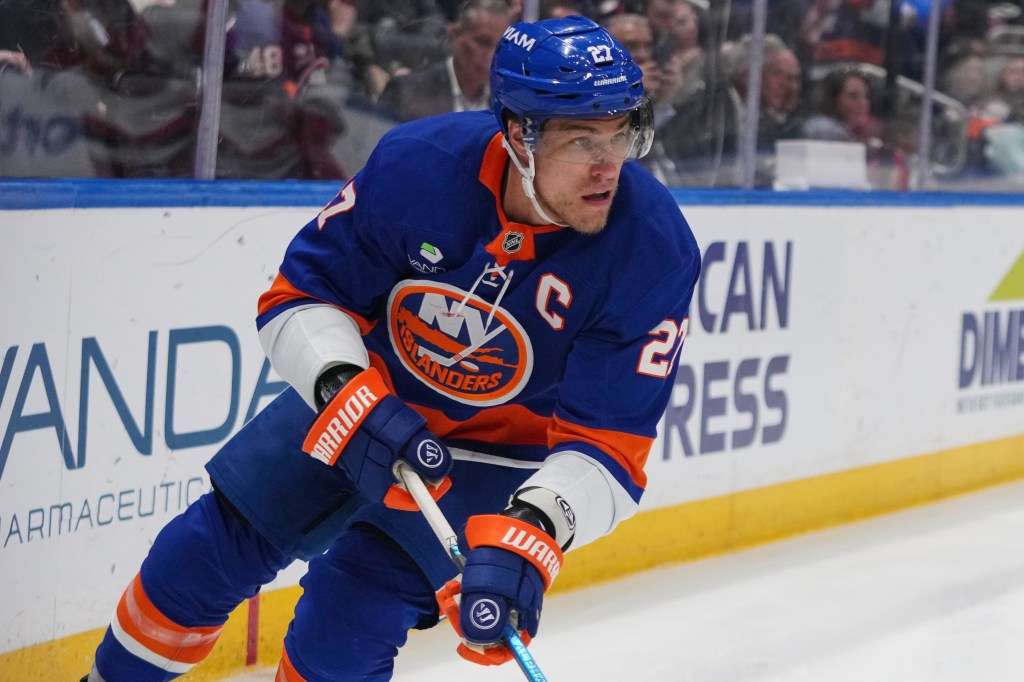 New York Islanders' Anders Lee (27) looks to pass during an NHL hockey game.