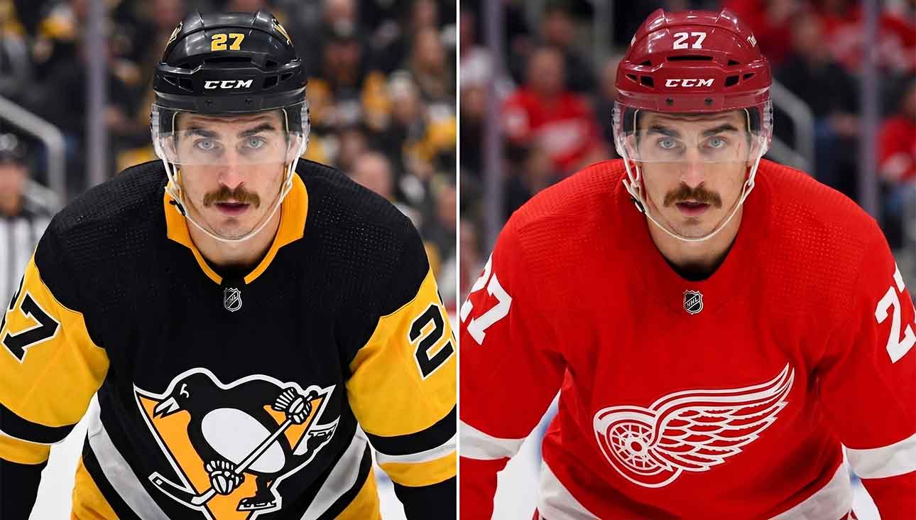 A close-up portrait of hockey player Mason Marchment with intense blue eyes and a mustache, wearing a white Seattle Kraken jersey, who is currently a pending UFA for the Columbus Blue Jackets and a target for the Pittsburgh Penguins and Detroit Red Wings in NHL free agency.