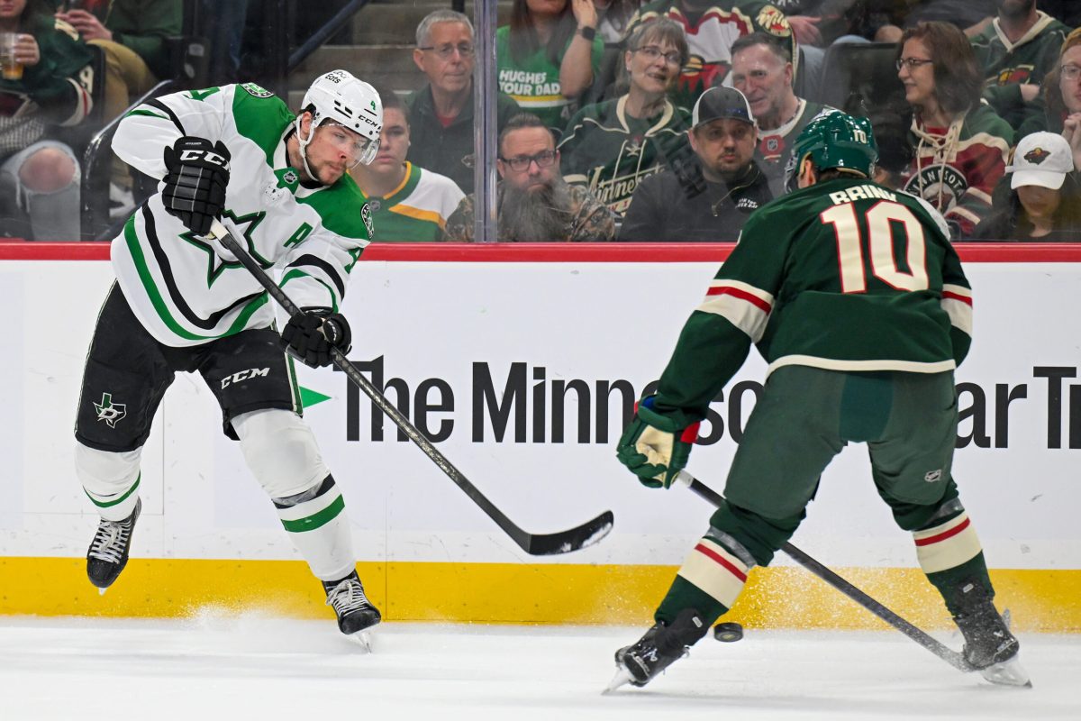 Mar 21, 2026; Saint Paul, Minnesota, USA; Dallas Stars defensemen Miro Heiskanen (4) shoots the puck between the legs of Minnesota Wild forward Bobby Brink (10) during the first period at Grand Casino Arena. Mandatory Credit: Nick Wosika-Imagn Images