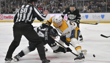 Linesman CJ Murray (68) drops the puck as Los Angeles Kings right wing Alex Laferriere (14) and Nashville Predators left wing Erik Haula face off during the second period of an NHL hockey game Thursday, April 2, 2026, in Los Angeles. (AP Photo/Jayne Kamin-Oncea)