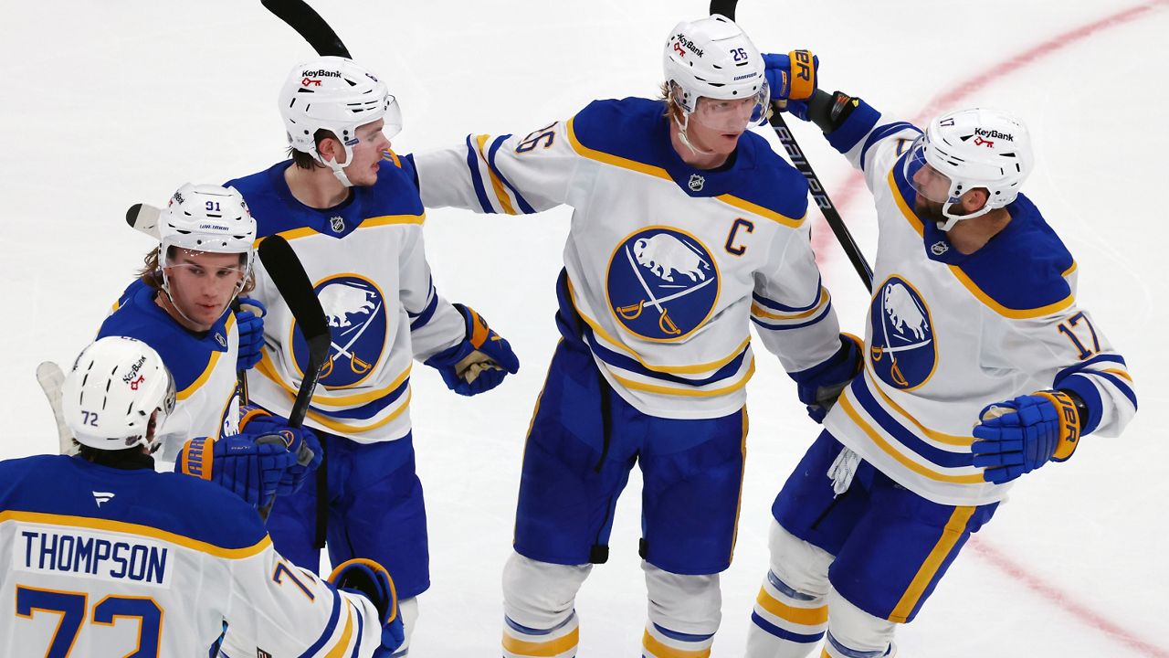 Buffalo Sabres' Rasmus Dahlin (26) celebrates his goal with Tage Thompson (72), Josh Doan (91), Zach Benson (6) and Jason Zucker (17) during the second period of an NHL hockey game against the Boston Bruins, Thursday, Oct. 30, 2025, in Boston. (AP Photo/Michael Dwyer)