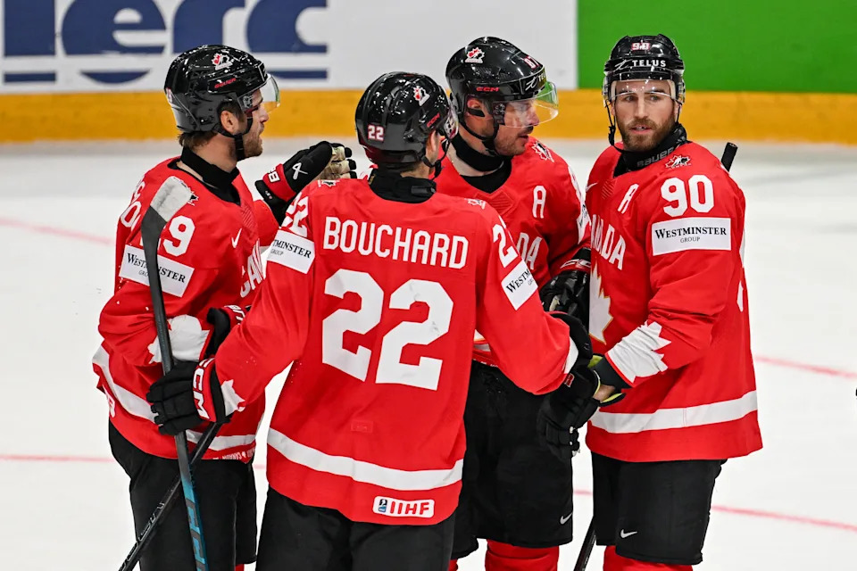 Canada's forward #90 Ryan O'Reilly (L) celebrates with teammates after scoring his team's fourth goal during the group B match between Canada and Denmark at the IIHF Ice Hockey Men's World Championship at BFC Arena, in Fribourg, Switzerland, on May 18, 2026. (Photo by Fabrice COFFRINI / AFP via Getty Images)