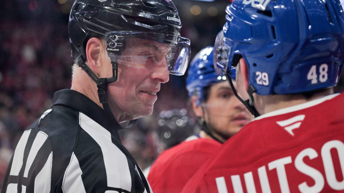 referee Eric Furlatt (27) interacts with Montreal Canadiens defenseman Lane Hutson (48) after Hutson got hit by a high stick during the third period of the game against the Florida Panthers at the Bell Centre.