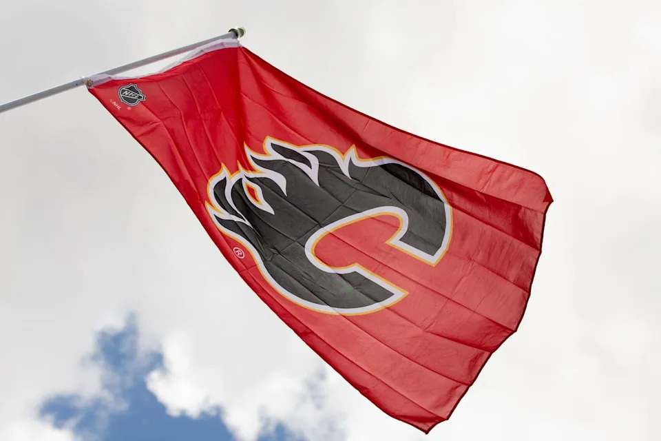 A Flames flag flies above a strip mall in Calgary on May 3, 2022.