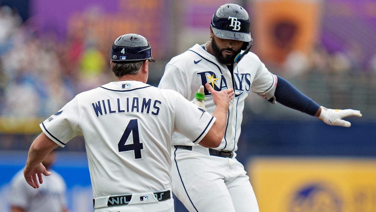 Tampa Bay Rays' Junior Caminero celebrates his solo home run with third base coach Brady Williams (4) during the first inning of a baseball game Sunday, May 17, 2026, in St. Petersburg, Fla. (AP Photo/Chris O'Meara)