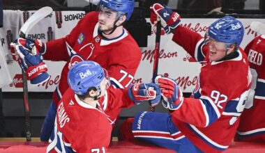 Montreal Canadiens' Jake Evans (71) celebrates with teammates Kirby Dach (77) and Patrik Laine (92) after scoring against the Tampa Bay Lightning during third period NHL hockey action in Montreal, Tuesday, January 21, 2025. (Graham Hughes/The Canadian Press via AP)