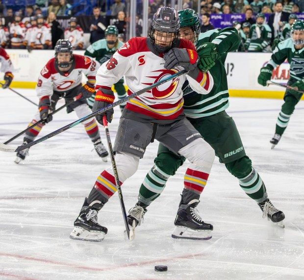 Boston Fleet's Riley Brengman, right, battles Ottawa Charge's Emily Clark for the puck during Thursday's game in Lowell. (James Thomas for the Lowell Sun)