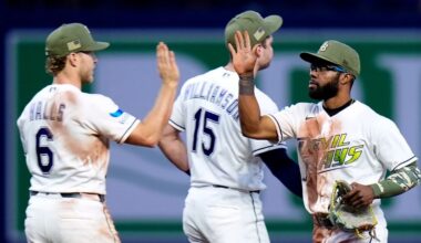 Tampa Bay Rays center fielder Cedric Mullins celebrates with shortstop Taylor Walls (6) and second baseman Ben Williamson (15) after the team defeated the Miami Marlins during a baseball game Friday, May 15, 2026, in St. Petersburg, Fla. (AP Photo/Chris O'Meara)