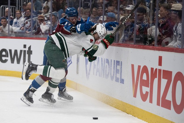 Center Parker Kelly (17) of the Colorado Avalanche tries to put defenseman Brock Faber (7) of the Minnesota Wild into the boards during the first period of Game 1 of the second round of the Stanley Cup Playoffs on Sunday, May 3, 2026, at Ball Arena in Denver. (Photo by Timothy Hurst/The Denver Post)