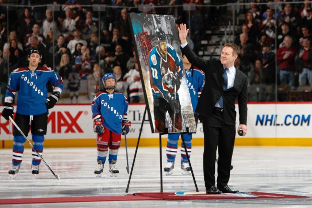 FILE - Retired Colorado Avalanche player Claude Lemieux waves to fans as he is honored for his years on the ice before the Avalanche host the New Jersey Devils in the first period of an NHL hockey game in Denver, Saturday, Jan. 16, 2010. (AP Photo/David Zalubowski, File)