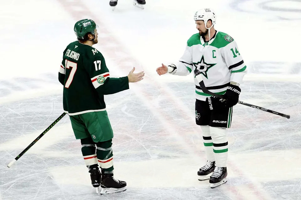 Dallas Stars left wing Jamie Benn (14) shakes hands with Minnesota Wild left wing <a class="link " href="https://sports.yahoo.com/nhl/players/4779/" data-i13n="sec:content-canvas;subsec:anchor_text;elm:context_link" data-ylk="slk:Marcus Foligno;sec:content-canvas;subsec:anchor_text;elm:context_link;itc:0" data-yga="{"yLinkElement":"context_link","yModuleName":"content-canvas","yLinkText":"Marcus Foligno","ySubModuleName":"anchor_text","yHasCommerce":false}">Marcus Foligno</a> (17) following Game 6 of a first-round NHL hockey playoff series in St. Paul, Minnesota, April 30, 2026. The Stars lost the game. 5-2, and the series. (Tom Fox/The Dallas Morning News)
