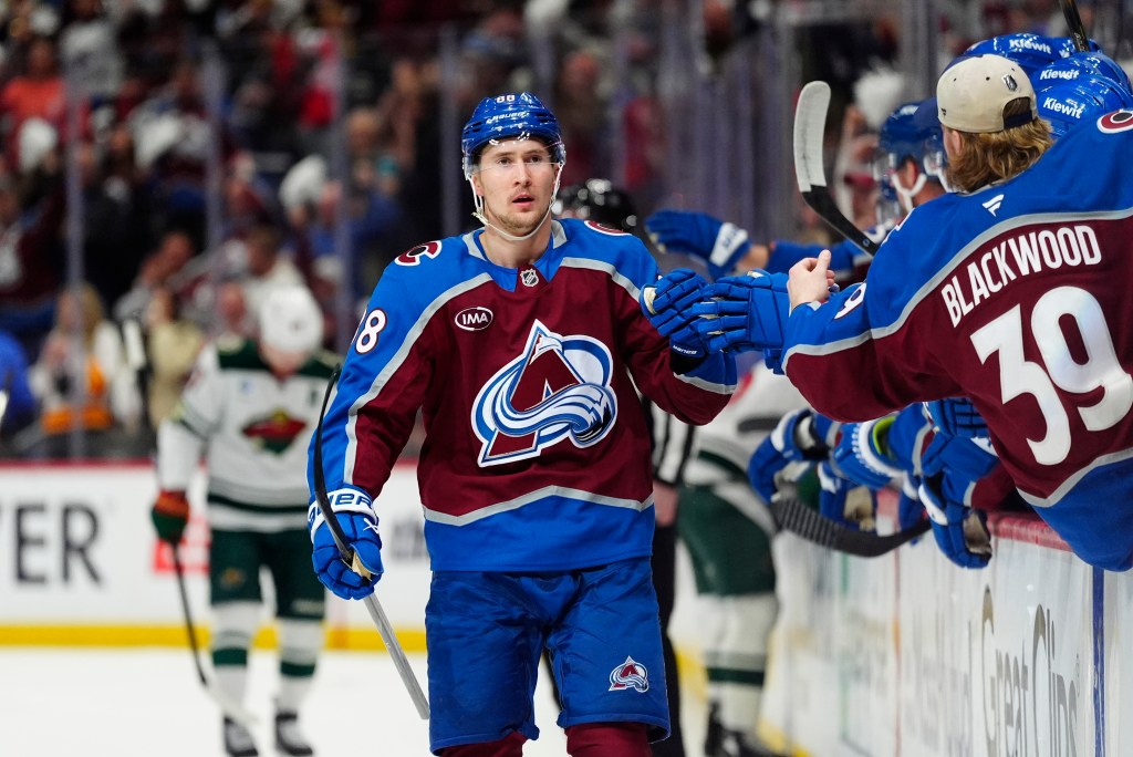Colorado Avalanche player Martin Necas (88) celebrating a goal with his teammates during a game.