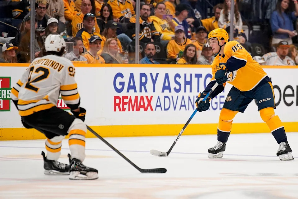 Nashville Predators defenseman Ryan Ufko passes the puck past Boston Bruins center Marat Khusnutdinov (92) during the third period at Bridgestone Arena in Nashville, Tenn., Thursday, March 5, 2026.