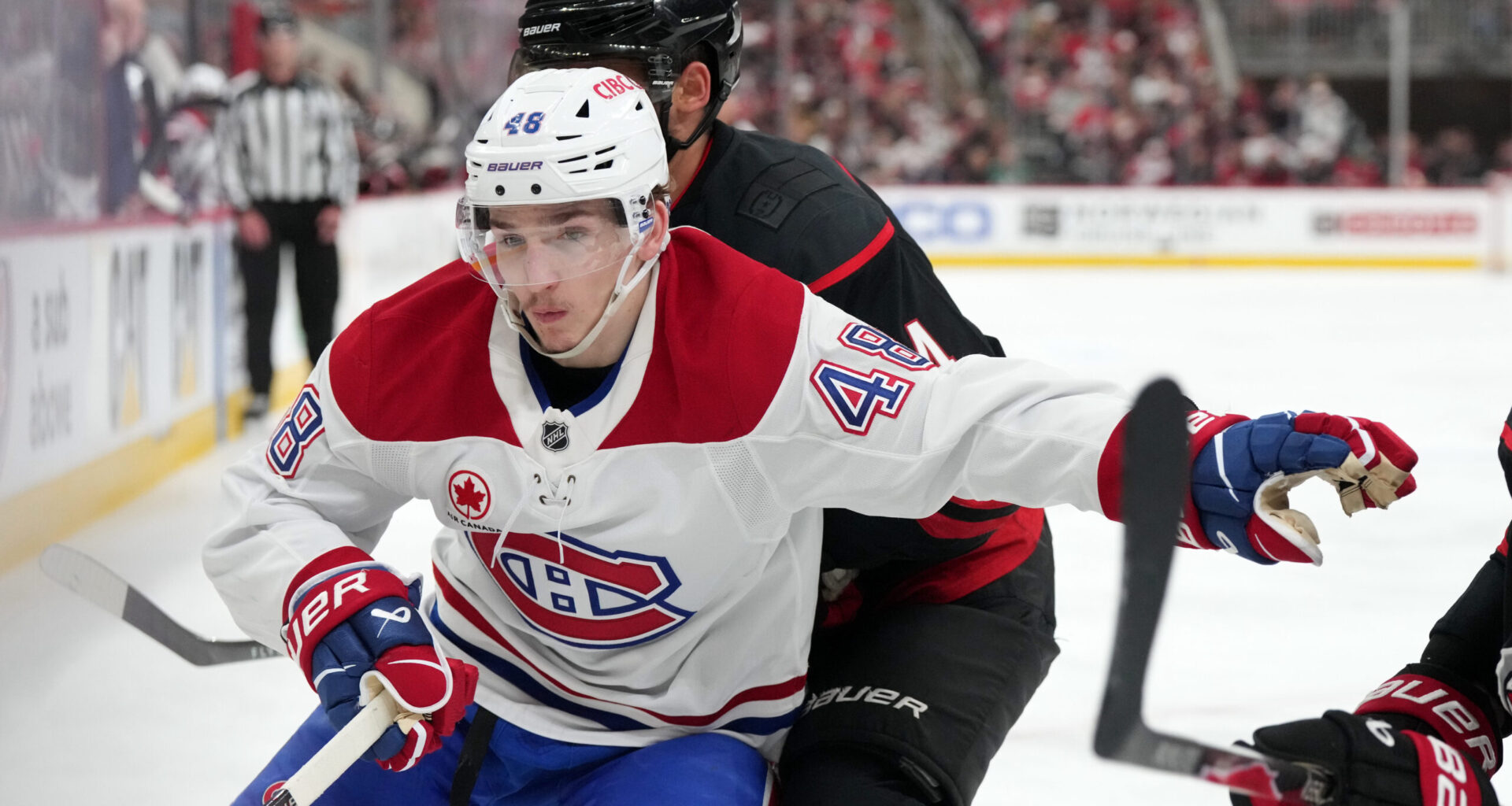 Montreal Canadiens defenseman Lane Hutson (48) vies for the position against Carolina Hurricanes center Seth Jarvis (24) in game five of the Eastern Conference Final of the 2026 Stanley Cup Playoffs during the third period at Lenovo Center