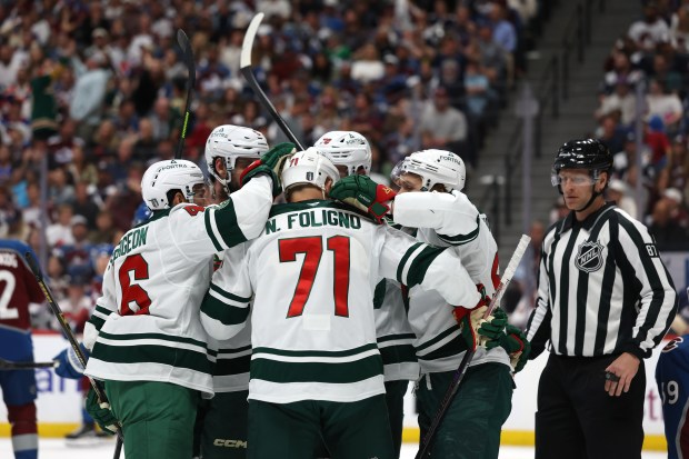 Wild forward Nick Foligno, center, celebrates with teammates after scoring a goal on in Game 5 of Minnesota's second-round playoff series in Colorado on Wednesday, May 13, 2026. Foligno scored twice in the Wild's 4-3 overtime loss at Ball Arena. (Matthew Stockman/Getty Images)