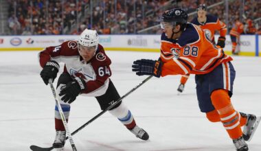 Feb 22, 2018; Edmonton, Alberta, CAN; Colorado Avalanche forward Nail Yakupov (64) and Edmonton Oilers defensemen Brandon Davidson (88) chase a loose puck during the second period at Rogers Place. Mandatory Credit: Perry Nelson-Imagn Images