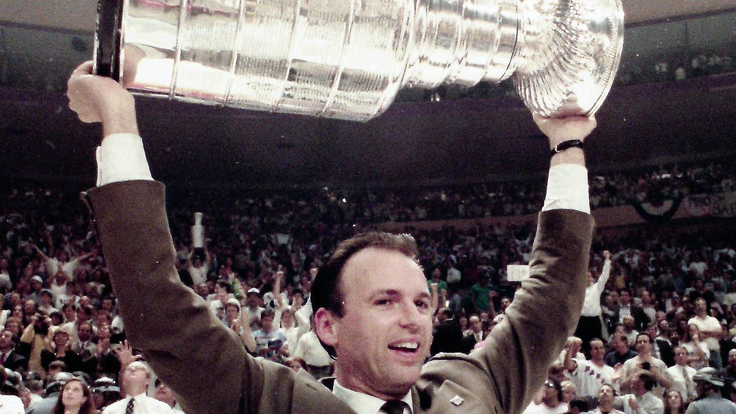 Rangers GM Neil Smith holds up the Stanley Cup after the Rangers defeated Vancouver 3-2 in game 7 of the Stanley Cup Finals at Madison Square Garden June 14, 1994.