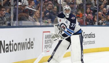 Apr 4, 2026; Columbus, Ohio, USA; Winnipeg Jets goalie Connor Hellebuyck (37) plays the puck on a Columbus Blue Jackets dump in during the second period at Nationwide Arena. Mandatory Credit: Russell LaBounty-Imagn Images