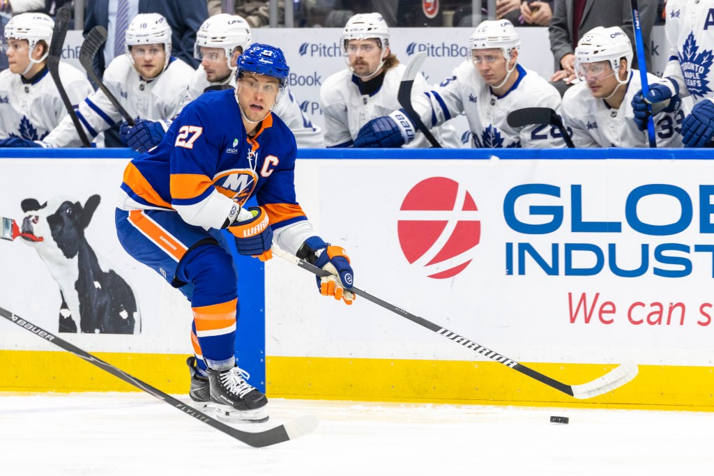 New York Islanders left wing Anders Lee (27) skates with the puck during a game against the Toronto Maple Leafs.