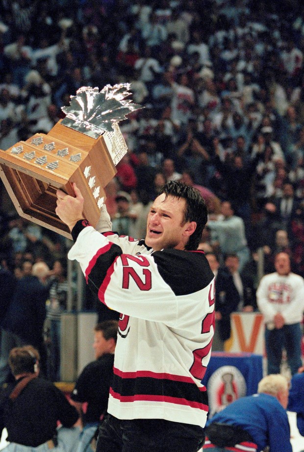 New Jersey Devils right wing Claude Lemieux holds the Conn Smythe Trophy after his team defeated the Detroit Red Wings 5-2 in Game 4 of the Stanley Cup Finals to win the championship Saturday night, June 24, 1995 at the Meadowlands Arena in East Rutherford, N.J. (AP Photo/Bill Kostroun, File)