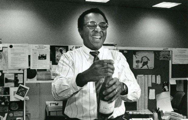 Pulitzer Prize winner Clarence Page celebrates in the newsroom of the Chicago Tribune after it was announced he won the prize for commentary on March 30, 1989. (José M. Moré/Chicago Tribune)