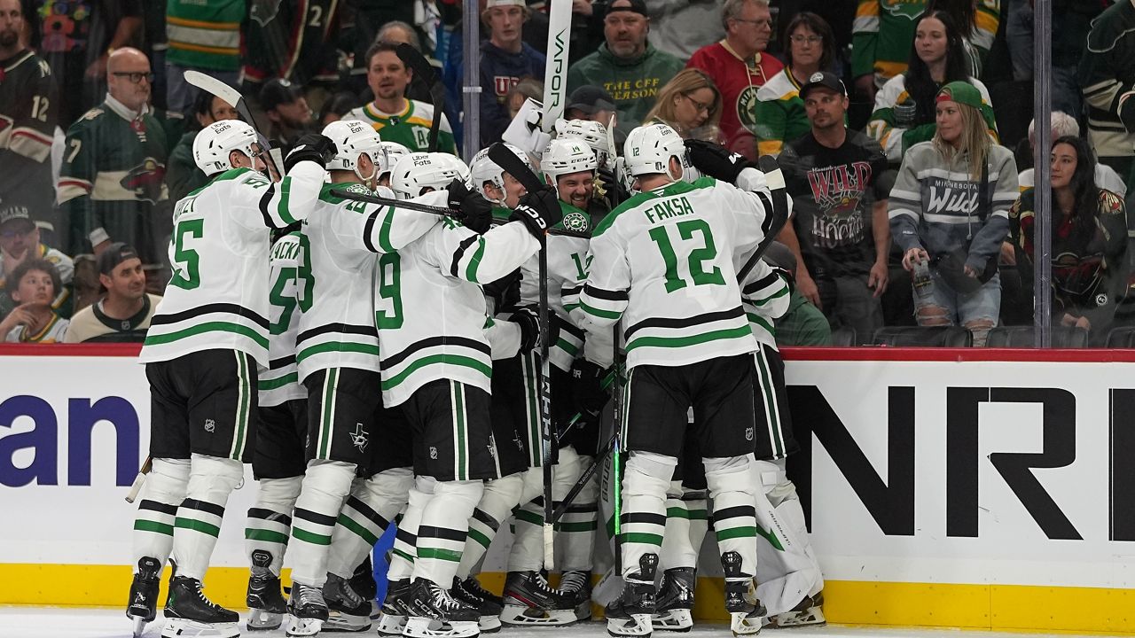 Dallas Stars players celebrate after the double-overtime win against the Minnesota Wild in Game 3 of the first round of the NHL Stanley Cup hockey playoffs early Thursday morning, April 23, 2026, in St. Paul, Minn. (AP Photo/Abbie Parr)