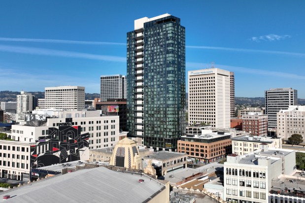 A drone view shows the 1900 Broadway apartment building, left, in downtown Oakland on April 7, 2026. (Jane Tyska/Bay Area News Group)