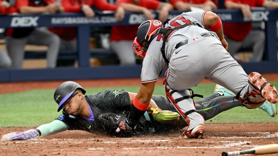 Washington Nationals catcher Keibert Ruiz (20) tags Tampa Bay Rays' Richie Palacios out at home on a fielder's choice during the third inning of a baseball game Saturday, June 20, 2026, in St. Petersburg, Fla. (AP Photo/Jason Behnken)