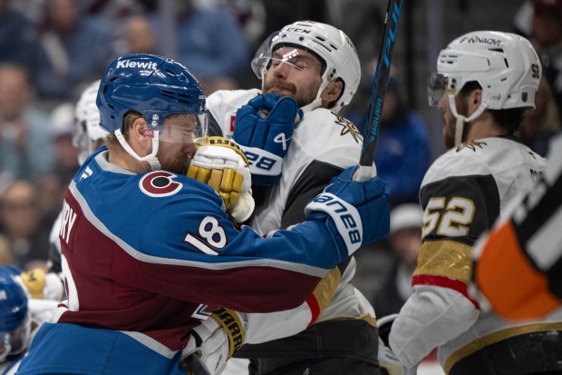 Right wing Cole Smith (22) of the Vegas Golden Knights gets a lick in on center Jack Drury (18) of the Colorado Avalanche during the first period of Game 2 of the Western Conference Finals of the Stanley Cup Playoffs on Friday, May 22, 2026, at Ball Arena in Denver. (Photo by Timothy Hurst/The Denver Post)