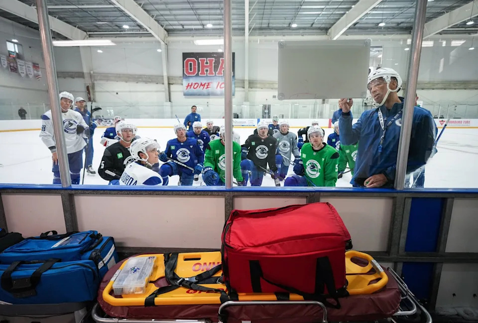 Manny Malhotra, head coach of the AHL's Abbotsford Canucks, diagrams a drill for players during the opening day of the Vancouver Canucks NHL hockey training camp, in Penticton, B.C., on Thursday, Sept. 19, 2024. THE CANADIAN PRESS/Darryl Dyck