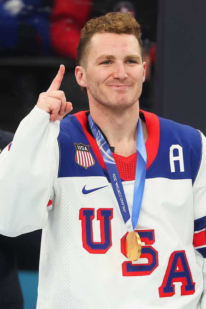 MILAN, ITALY - FEBRUARY 22: Gold medalist Matthew Tkachuk #19 of Team United States celebrates during the medal ceremony for Men's Ice Hockey following the Men's Gold Medal match between Canada and the United States on day 16 of the Milano Cortina 2026 Winter Olympic games at Milano Santagiulia Ice Hockey Arena on February 22, 2026 in Milan, Italy. (Photo by Gregory Shamus/Getty Images)