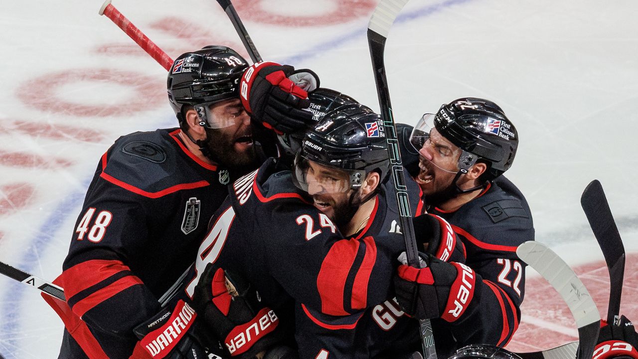Carolina Hurricanes' Jordan Martinook (48), Seth Jarvis (24), Shayne Gostisbehere (4) and Logan Stankoven (22) celebrate after Jarvis scored the game-winning goal against the Vegas Golden Knights in overtime of Game 2 of the Stanley Cup Final series in Raleigh, N.C., on Thursday, June 4, 2026. (AP File Photo/Ben McKeown)