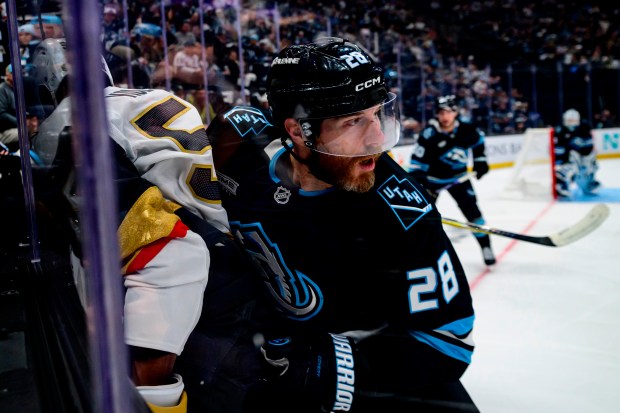 Mammoth defenseman Ian Cole checks Golden Knights right wing Keegan Kolesar into the boards during Game 4 of a first-round playoff series April 27, 2026, in Salt Lake City. (Tyler Tate/AP)