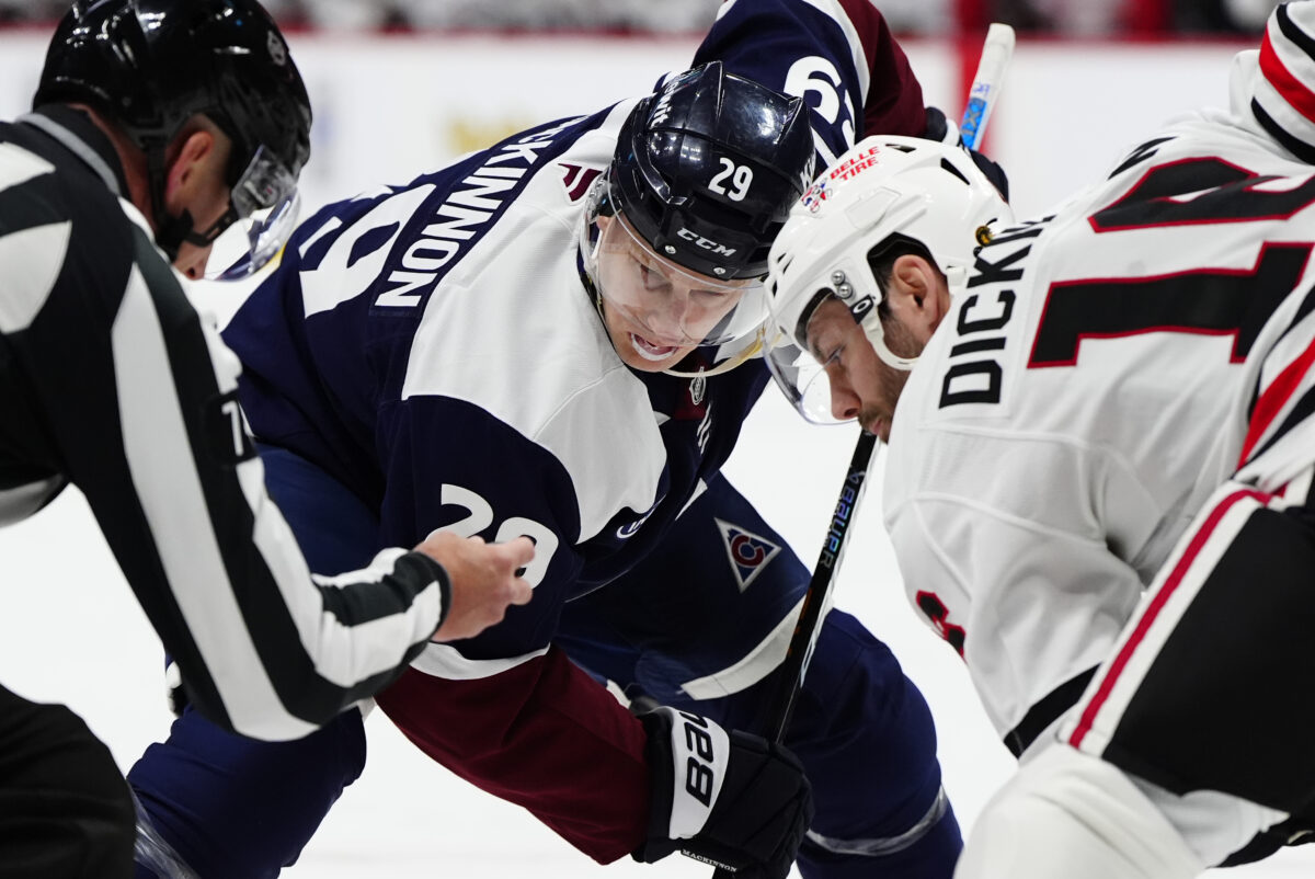 Feb 28, 2026; Denver, Colorado, USA; Colorado Avalanche center Nathan MacKinnon (29) and Chicago Blackhawks center Jason Dickinson (16) during a face off in the second period at Ball Arena. Mandatory Credit: Ron Chenoy-Imagn Images