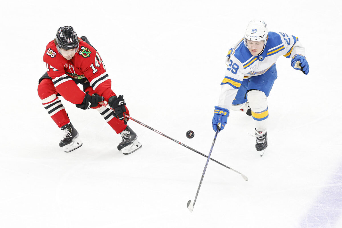 Apr 11, 2026; Chicago, Illinois, USA; Chicago Blackhawks defenseman Kevin Korchinski (14) battles for the puck with St. Louis Blues right wing Jonatan Berggren (29) during the second period at United Center. Mandatory Credit: Kamil Krzaczynski-Imagn Images