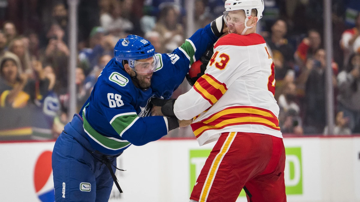 Calgary Flames forward Adam Klapka (43) fights with Vancouver Canucks Vincent Arseneau (68) in the third period at Rogers Arena. Calgary won 3-2 in overtime.
