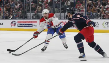 Montreal Canadiens defenseman Alexandre Carrier (45) passes the puck as Columbus Blue Jackets defenseman Zach Werenski (8) defends during the first period at Nationwide Arena.