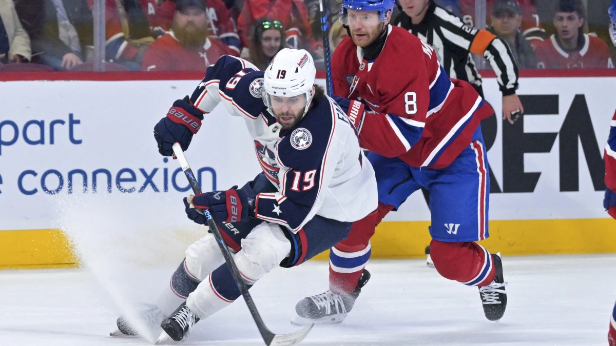 Columbus Blue Jackets forward Adam Fantilli (19) plays the puck and Montreal Canadiens defenseman Mike Matheson (8) defends during the first period at the Bell Centre.