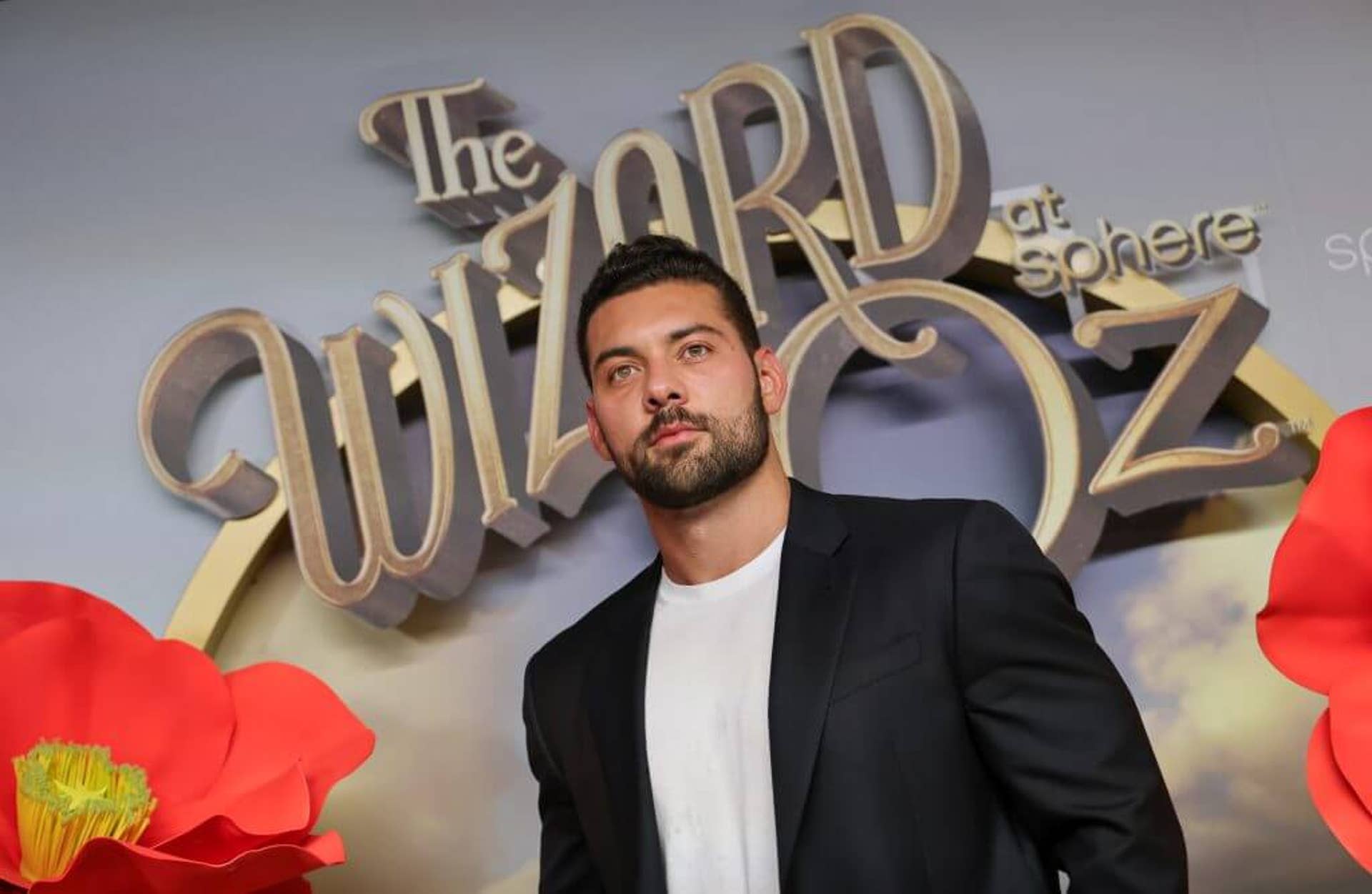 Quentin Dolan is pictured in front of a "The Wizard of Oz at Sphere" sign, attending the premier of The Wizard of Oz at Sphere