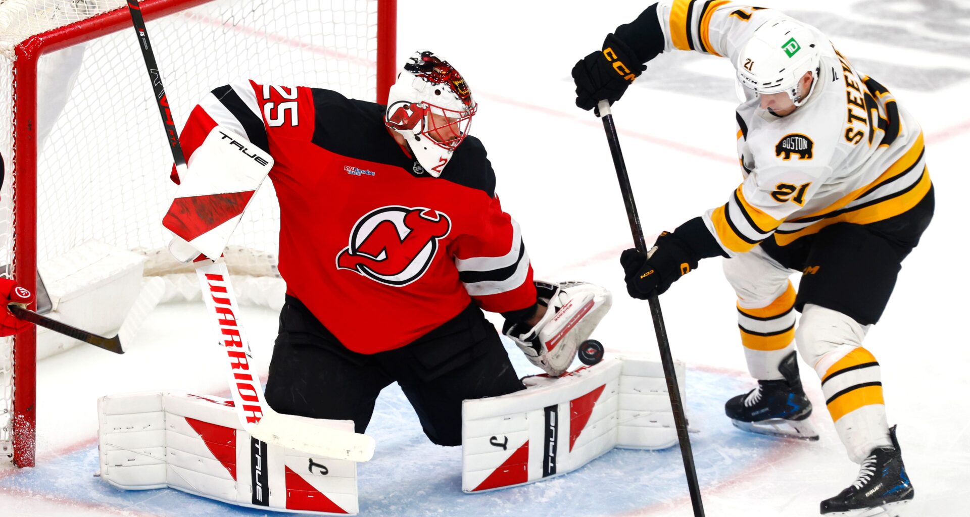 FILE - New Jersey Devils goaltender Jacob Markstrom (25) makes a save against Boston Bruins forward Alex Steeves (21) during the third period of an NHL hockey game, March 16, 2026, in Newark, N.J. (AP Photo/Noah K. Murray, File)