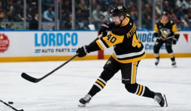 Elias Pettersson wearing a Pittsburgh Penguins home jersey while taking a powerful shot during an NHL game