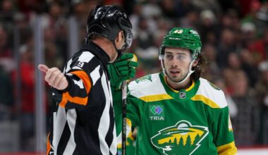 Minnesota Wild defenseman Quinn Hughes (43) talks with referee Dan O'Rourke (9) during overtime against the Chicago Blackhawks at Grand Casino Arena. Mandatory Credit: Matt Krohn-Imagn Images
