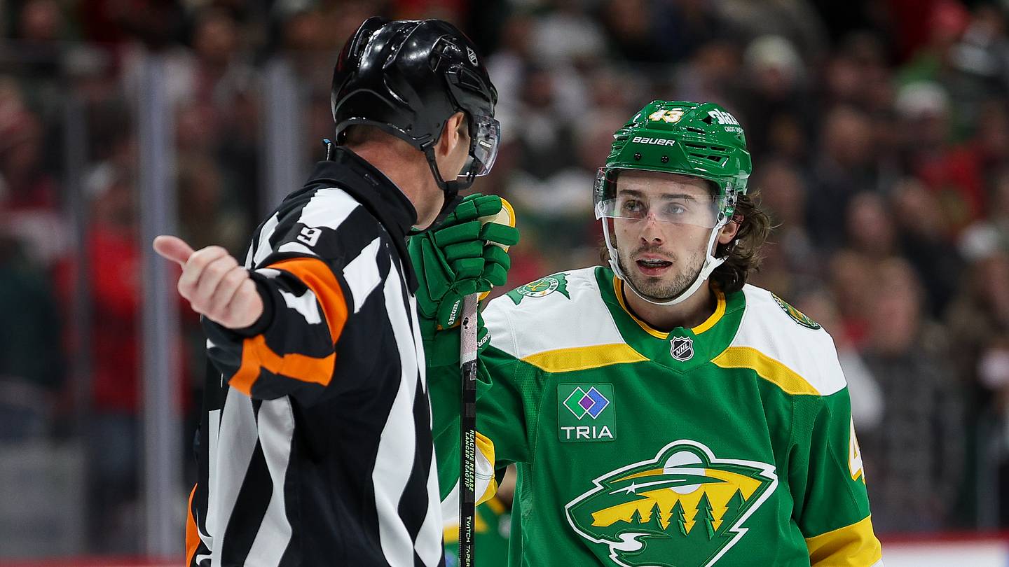 Minnesota Wild defenseman Quinn Hughes (43) talks with referee Dan O'Rourke (9) during overtime against the Chicago Blackhawks at Grand Casino Arena. Mandatory Credit: Matt Krohn-Imagn Images
